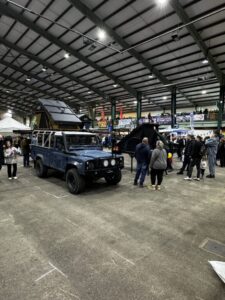 Crowds exploring the 4X4 Expo Staffordshire 2025, featuring rooftop tents, 4X4 awnings, and overlanding gear displays.